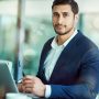 Portrait of an executive working on a laptop in an office